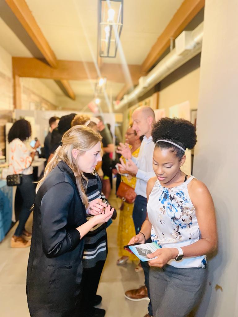 Two HBN members talking in a hallway